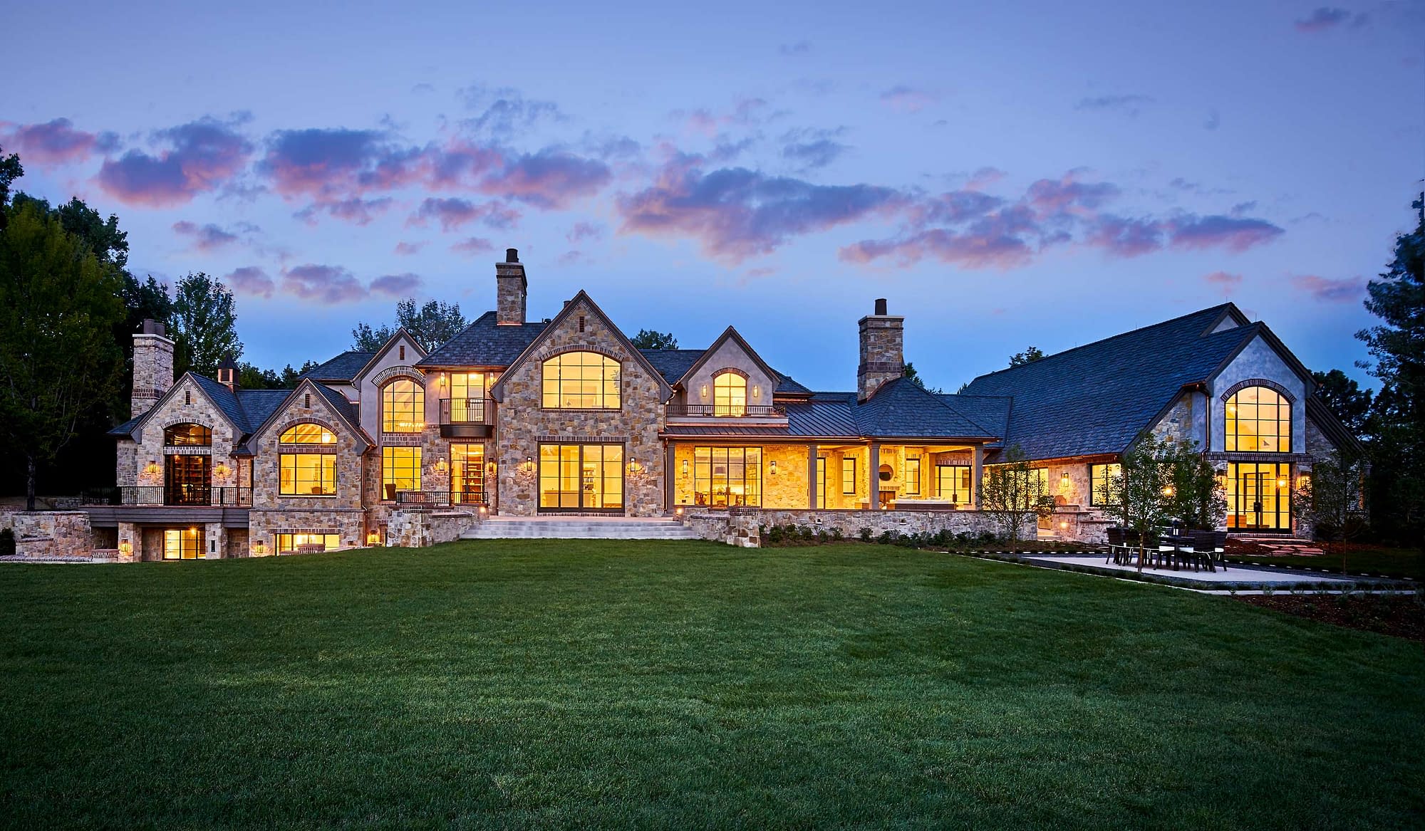 Breathtaking exterior shot at dusk of an estate remodel featuring Brombal's luxury metal windows and doors