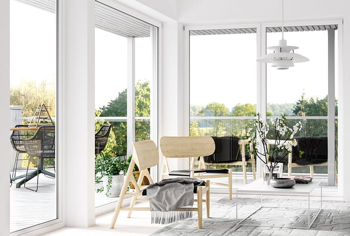 A sitting area is blanketed in natural light from minimal frame aluminum window and door systems