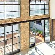 Hot rolled steel door and window systems flood this loft with natural light