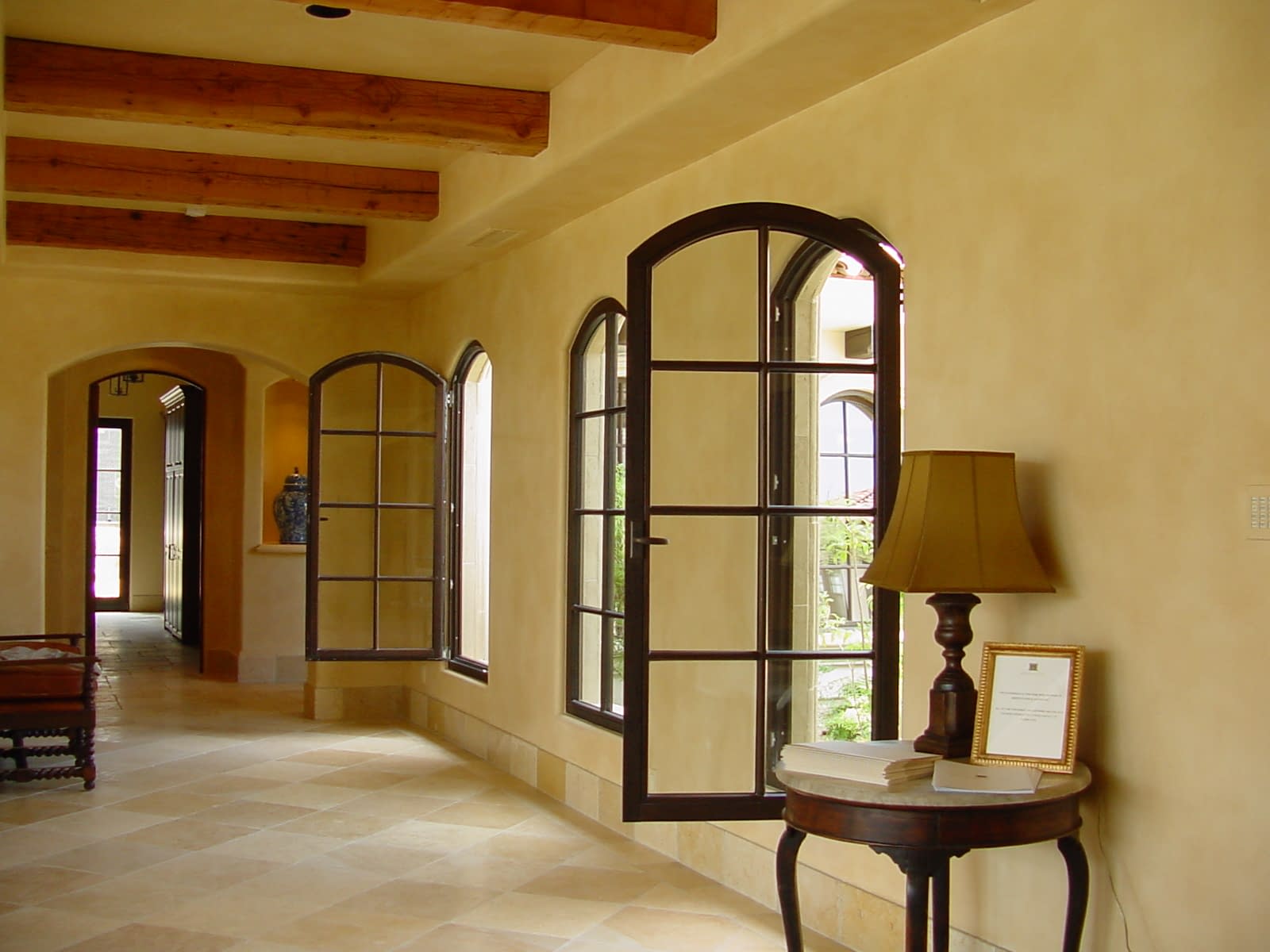 Arched wood tilt turn windows in this estate allows for airflow control