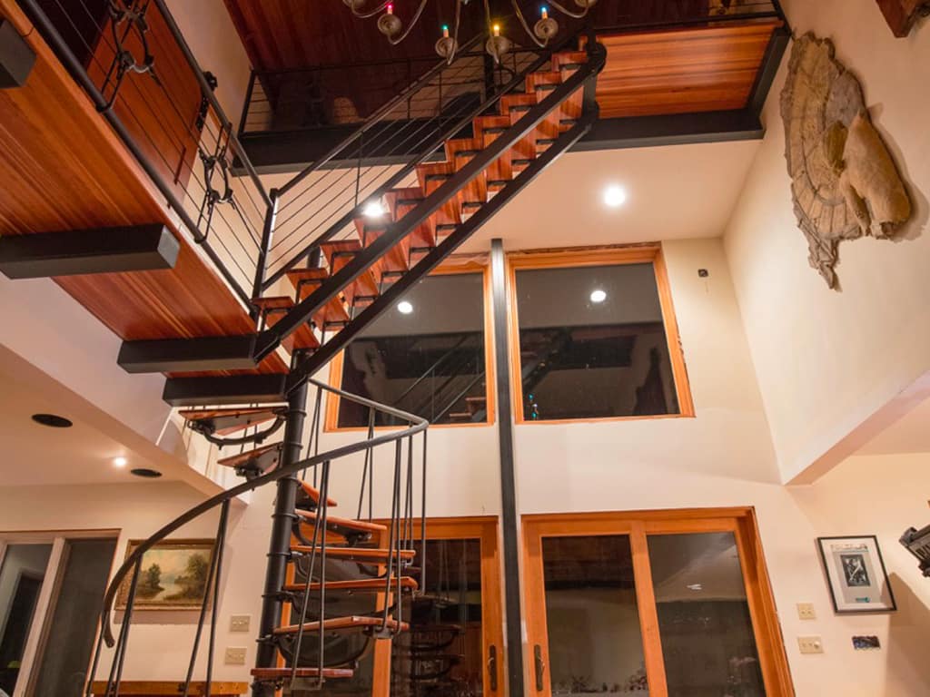 Iron railings and exposed stair components make up this multi level staircase.