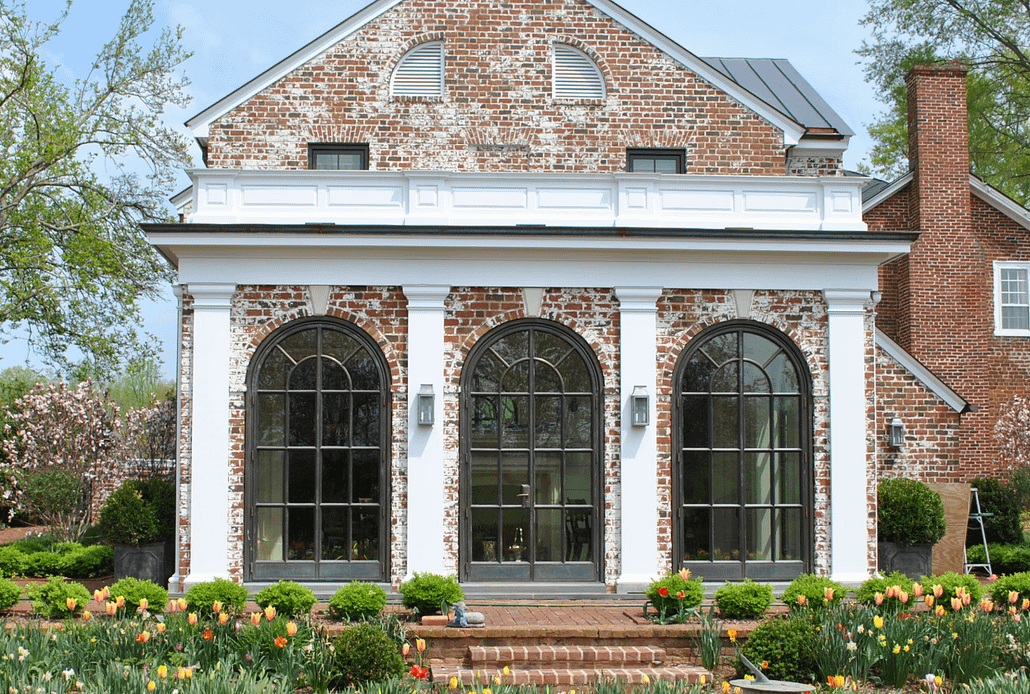 The arched bronze luxury metal windows and doors bring old world charm to this estate