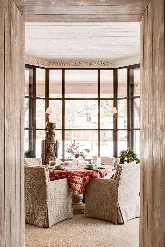 A dining room is accented by thermally broken steel bay window systems