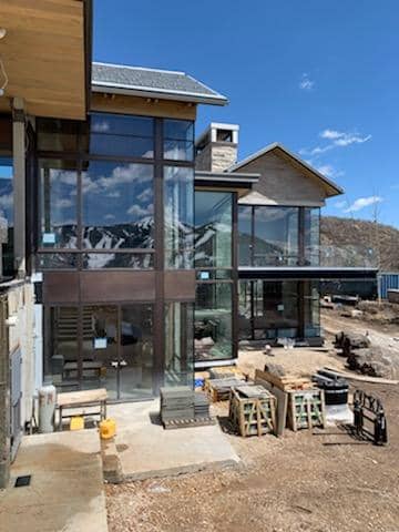 The rear elevation of this Park City mountain retreat has expansive window walls.