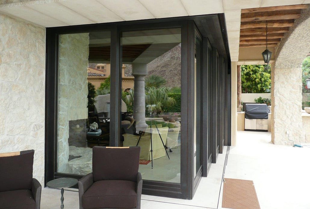 A corner meet bronze lift slide door system expands the entertaining space to the outdoor entertaining space