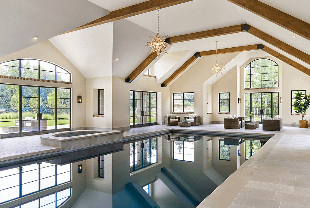 This serene pool is flooded with natural light beaming through thermally broken luxury metal windows and doors