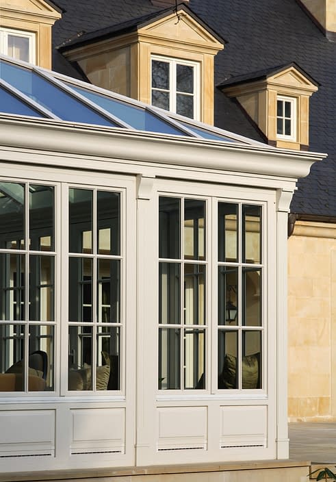 A sunroom featuring traditional white tilt/turn window systems