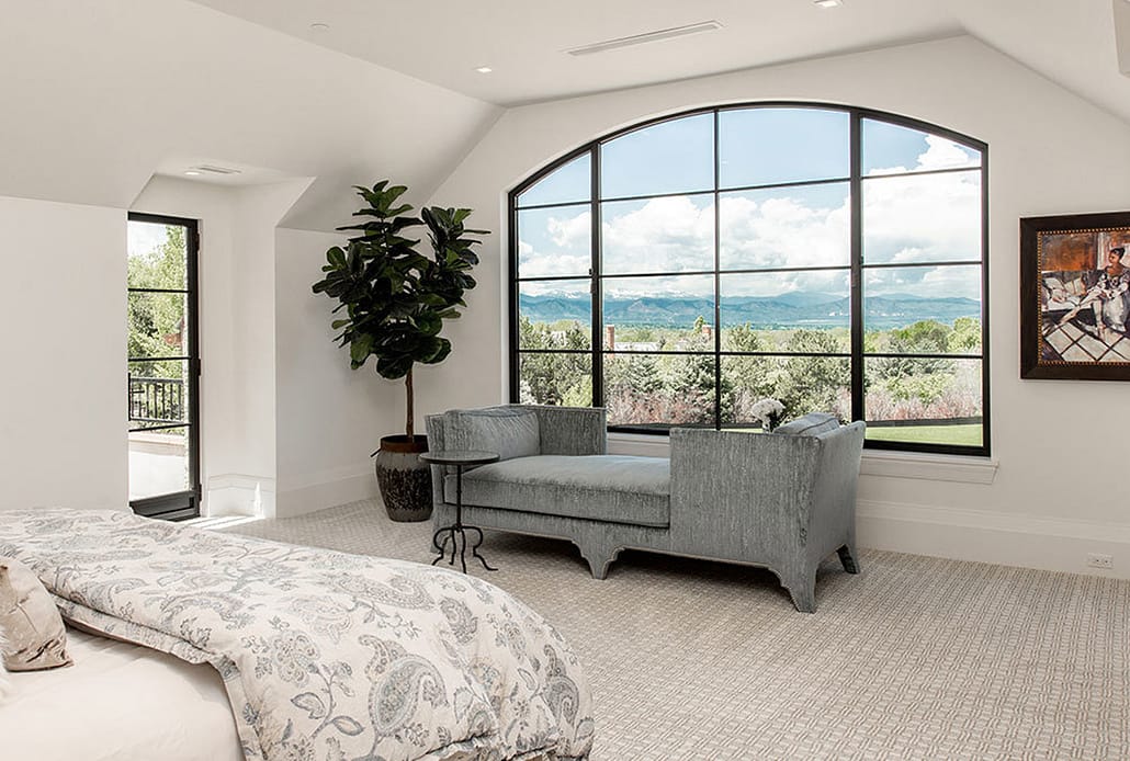 An oversized steel push out casement window with views of the Rocky Mountains