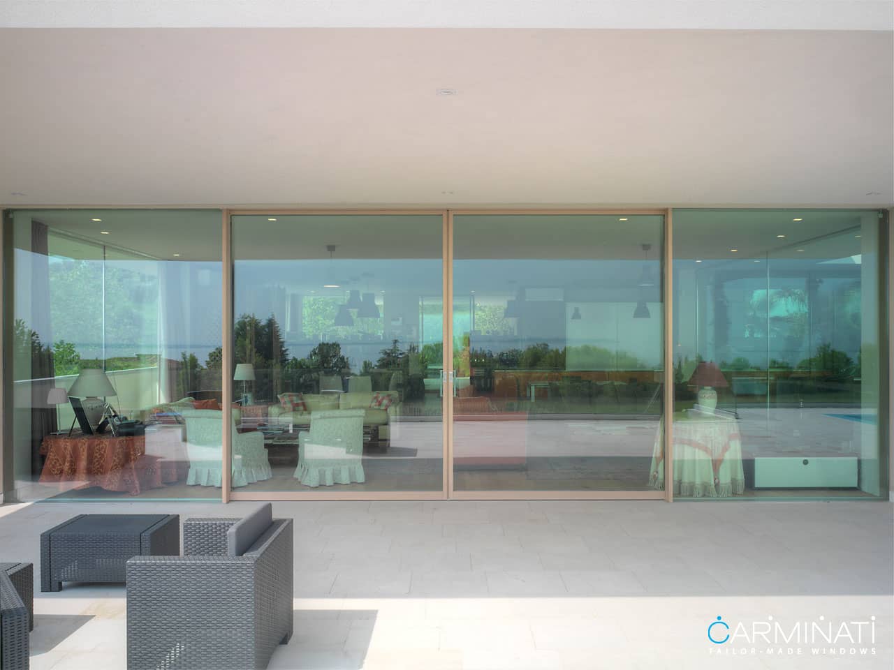 A minimal frame lift slide door system by Carminati opens this villa to the beautiful views of Saint Tropez