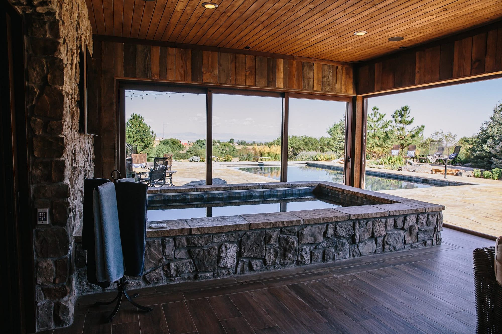Two lift slide doors open the hot tub area to the patio and pool