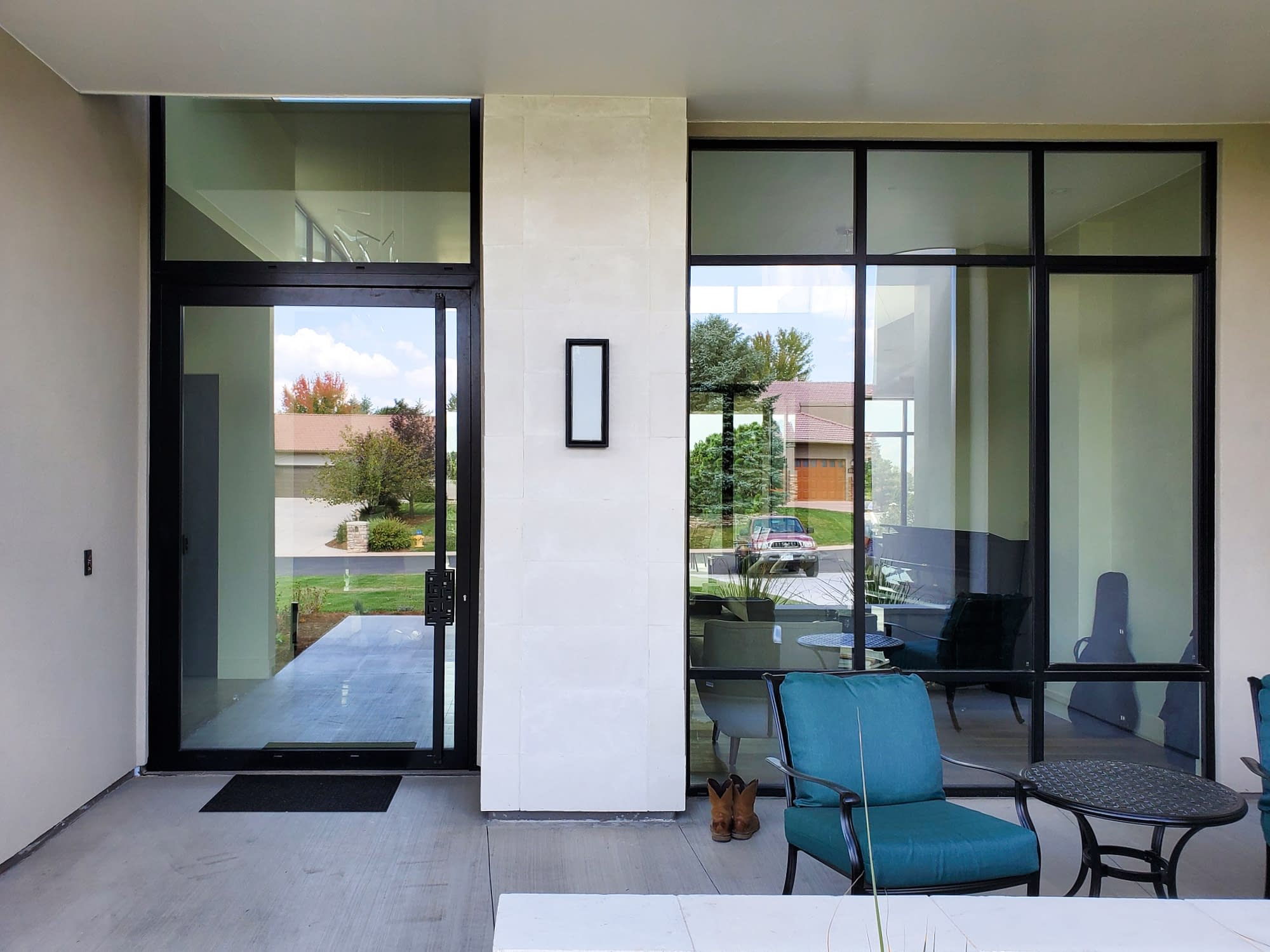 Natural light floods this home through the glass pivot door and curtain wall.