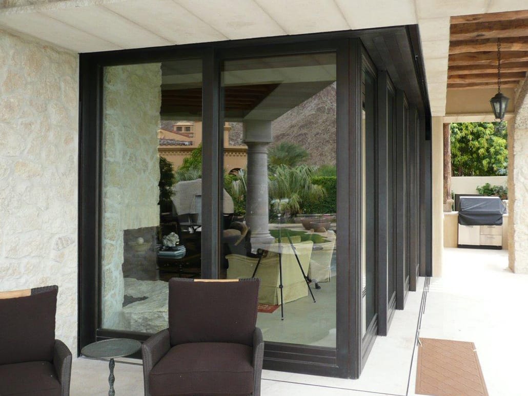 A multi-panel corner meet lift slide door in bronze material expands the living space to the outdoor sitting area