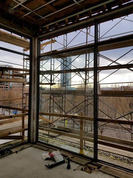 Our install techs continue to install the expansive glass in the oversized steel windows by Brombal.