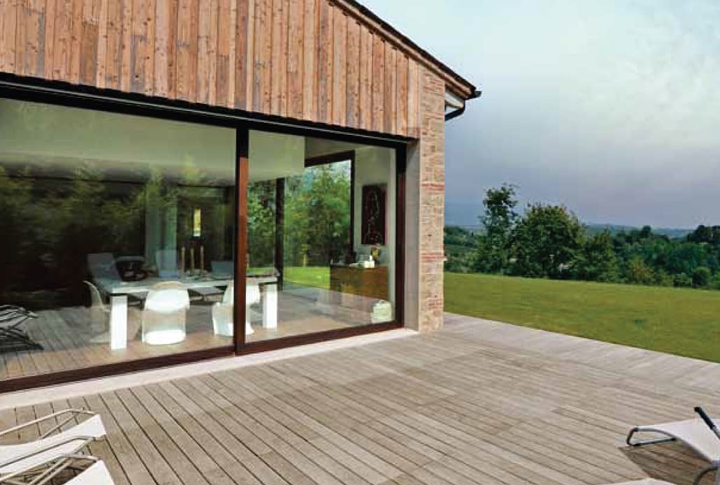 An oversized steel lift side door with a cor-ten finish creates a glass wall in which to enjoy the natural surroundings