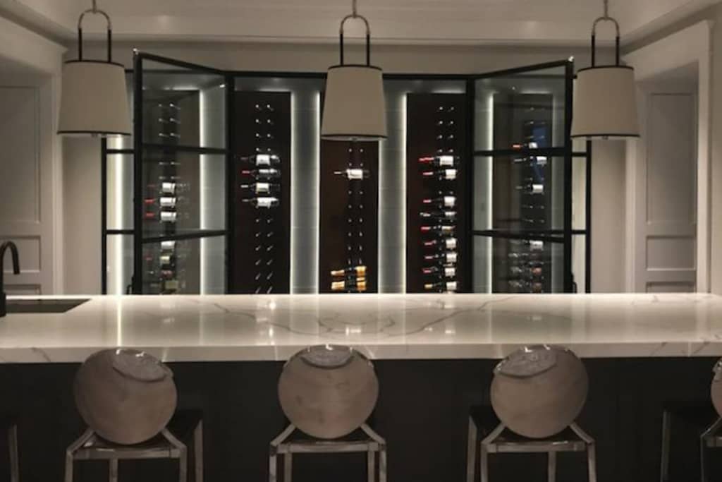 A minimal frame custom metal door system for a magnificent wine cellar