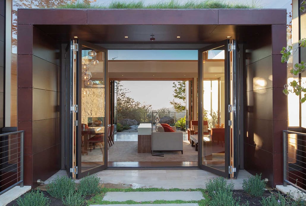 A four panel thermally broken steel folding door creates expansive openings in this modern villa