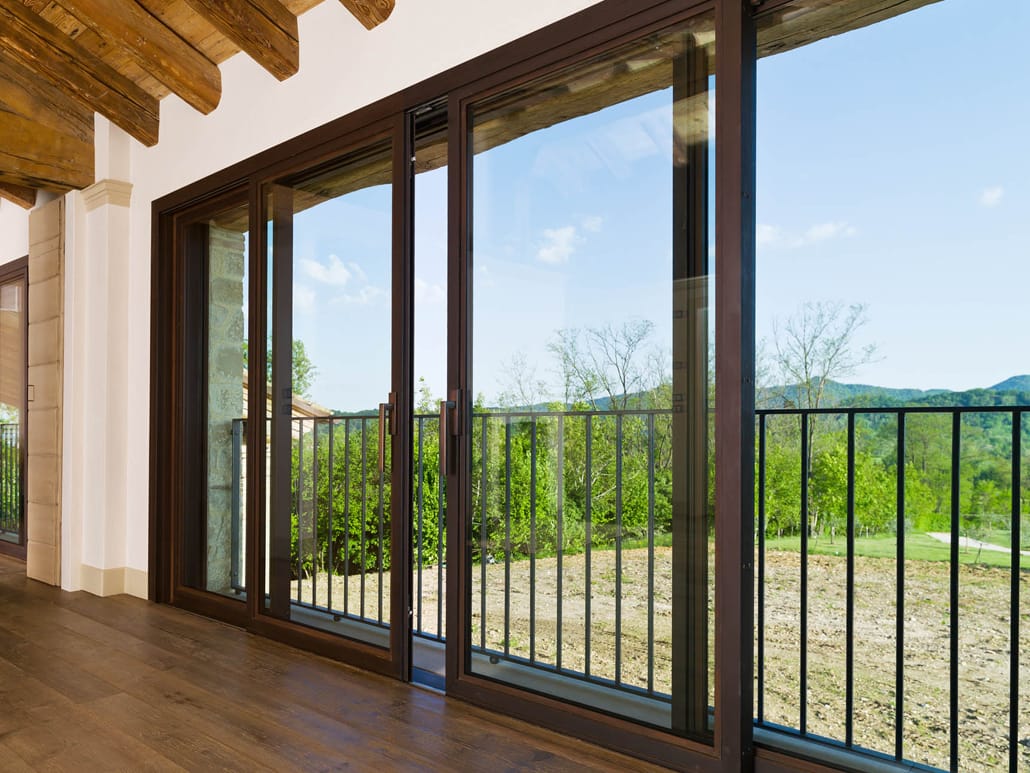 An oversized lift slide door in cor-ten material with expansive glass allows for unobstructed views