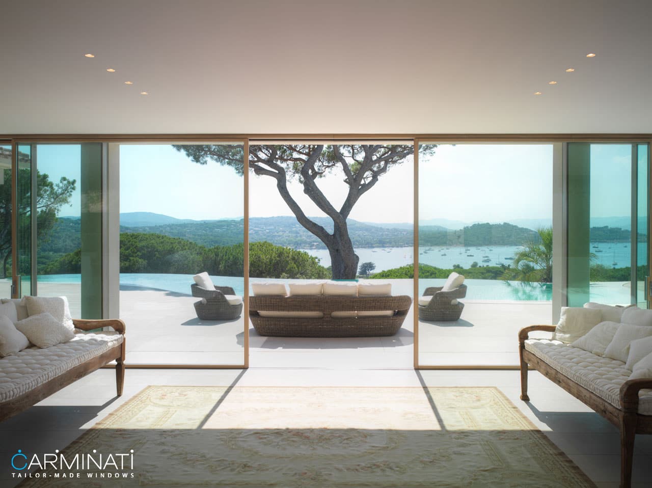 A minimal frame lift slide door system by Carminati opens this villa to the beautiful views of Saint Tropez