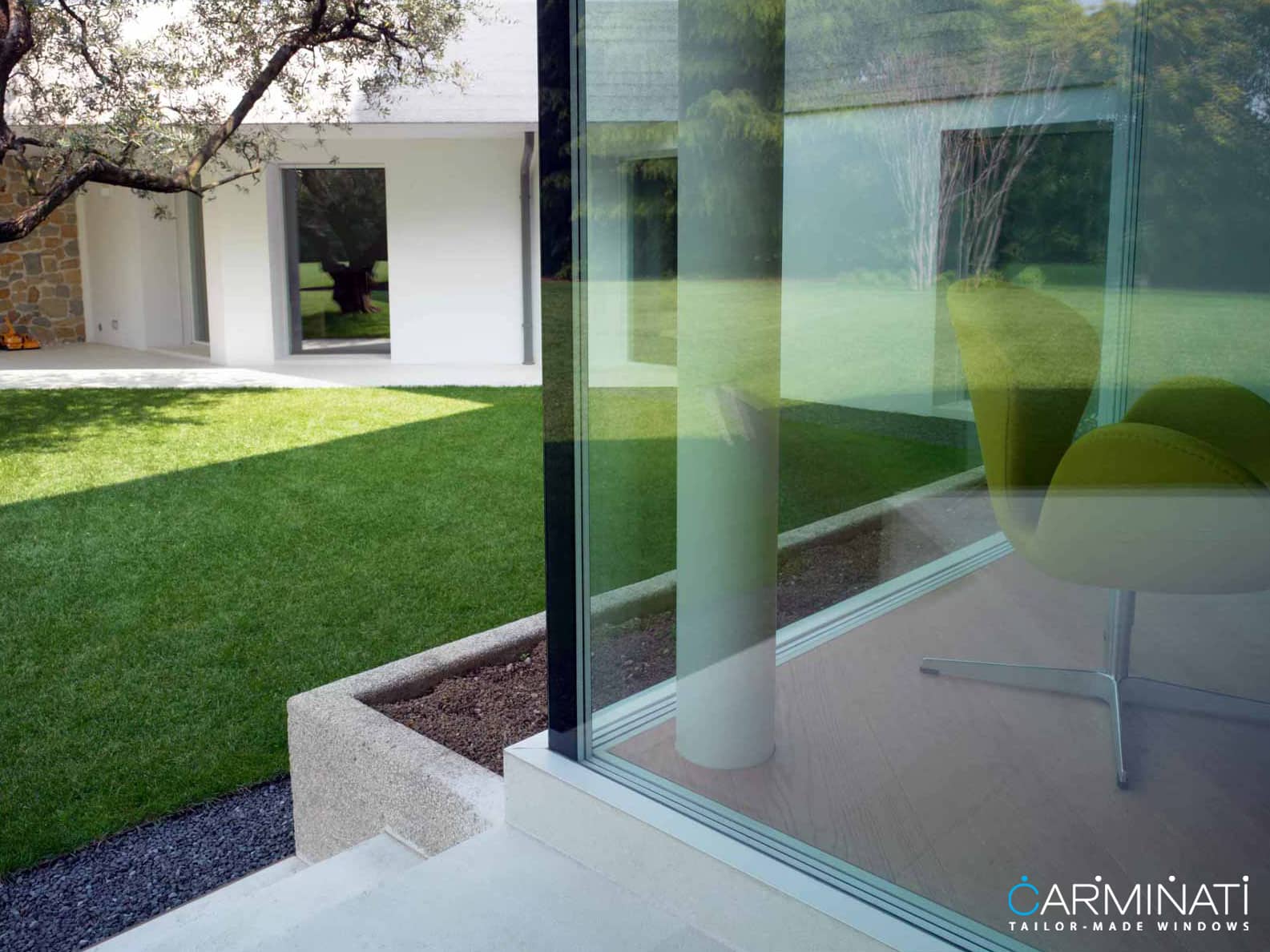 Natural lights fills this contemporary home through an expansive minimal frame glass corner meet window