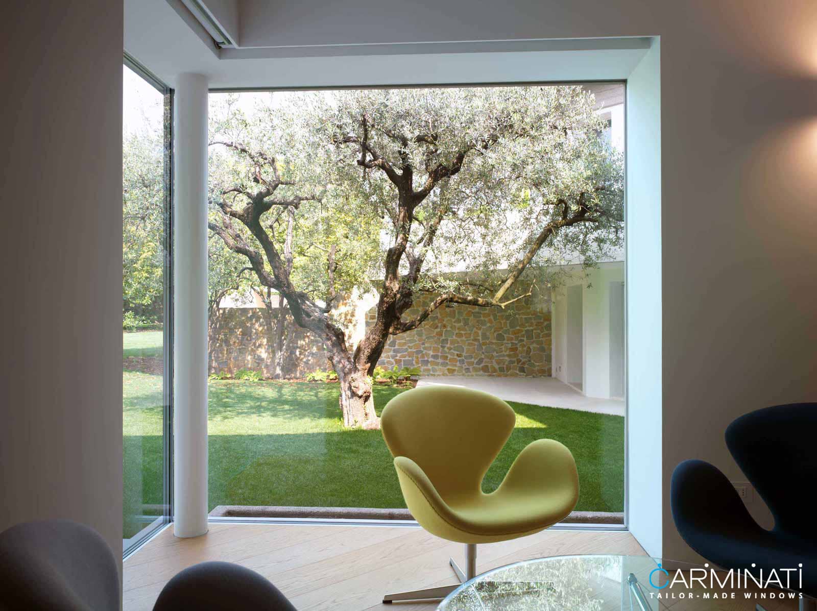 Natural lights fills this contemporary home through an expansive minimal frame glass corner meet window