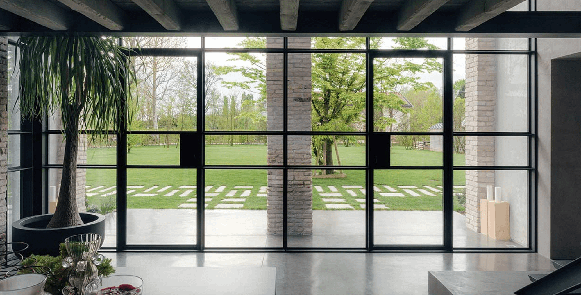 An entrance featuring two outswing minimal frame steel doors