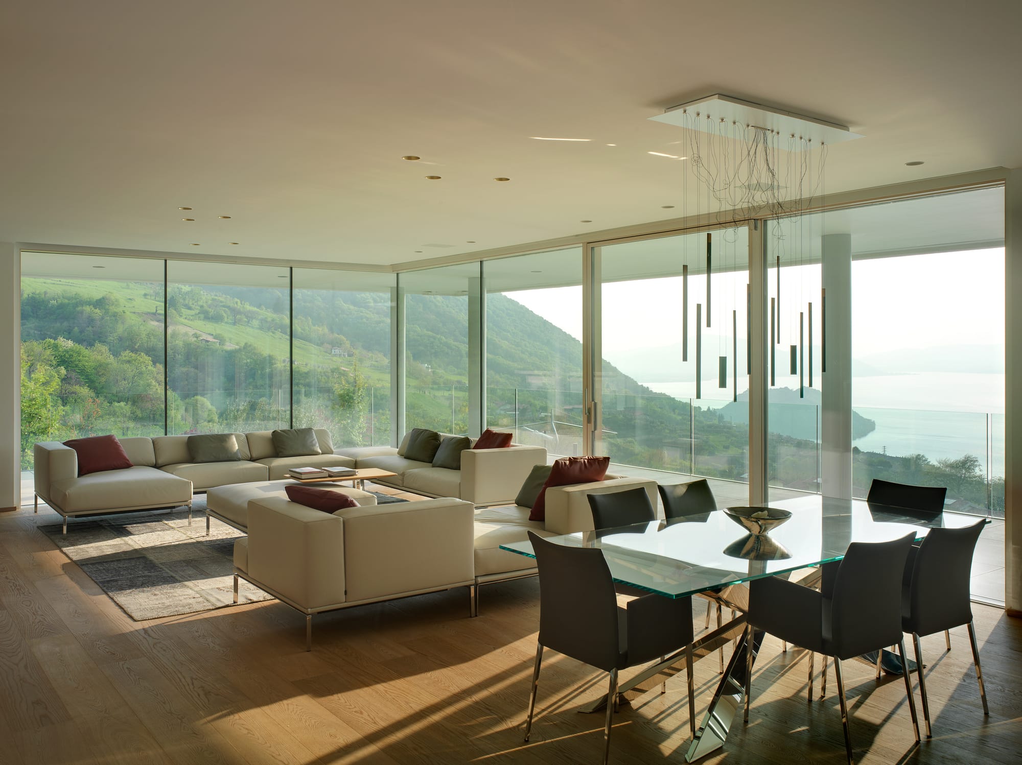 Floor to ceiling minimal frame glass windows and and oversized lift slide door provide unobstructed views