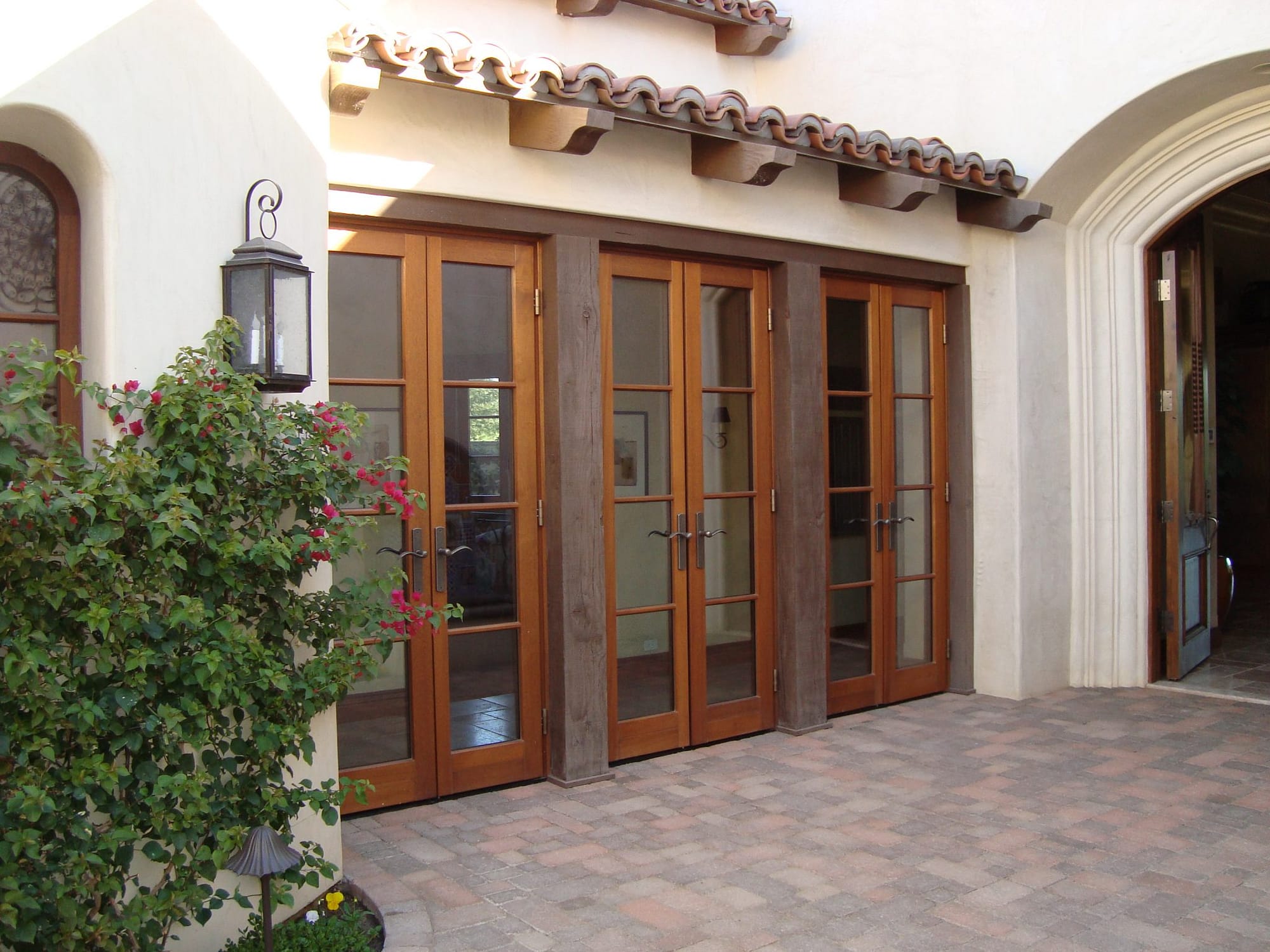 Three sets of outswing wood balcony doors by Veranda View