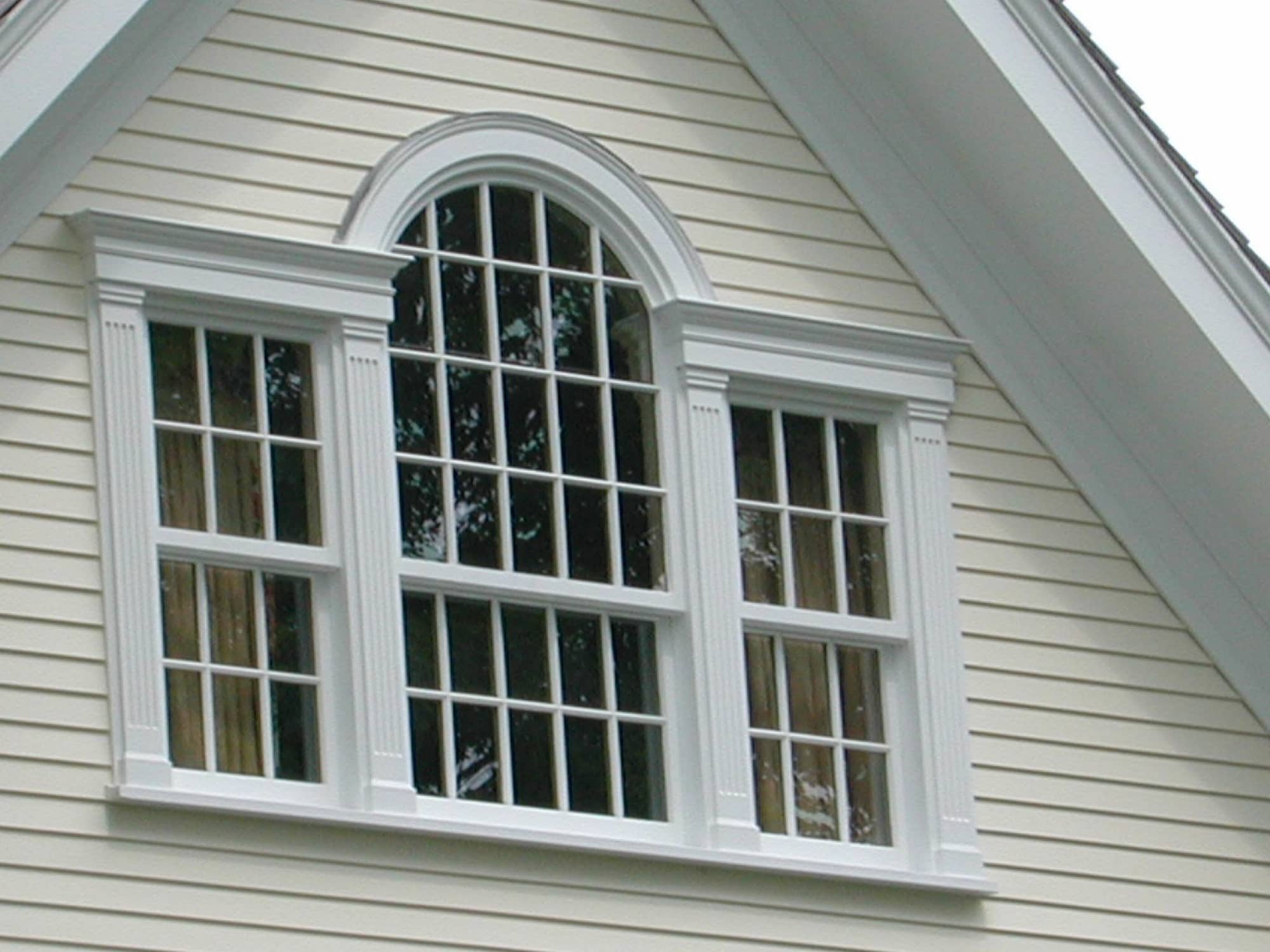 Window opening with three white double hung windows