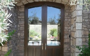 A custom double wood and glass entryway door