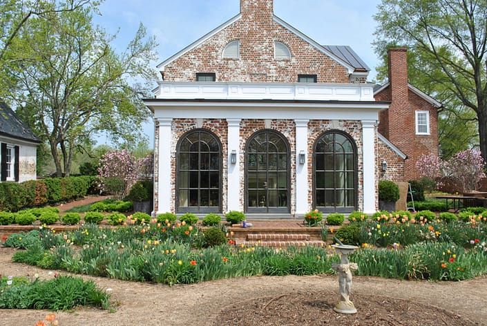 The arched bronze windows and doors bring old world charm to this estate