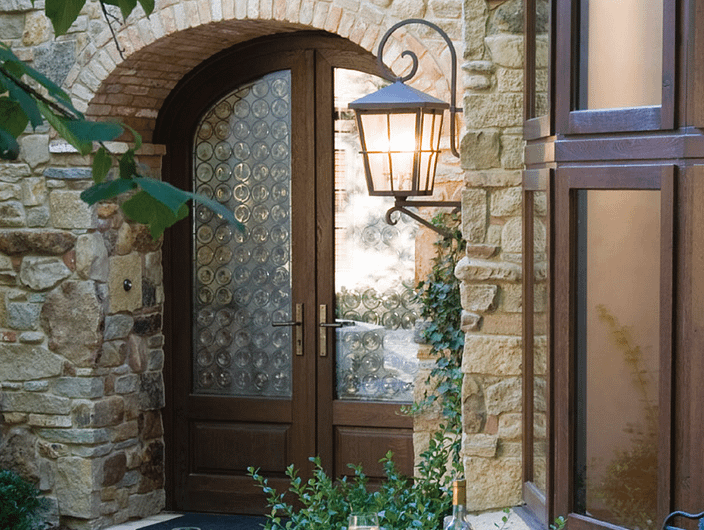 Custom European wood entryway door with decorative glass by Veranda View