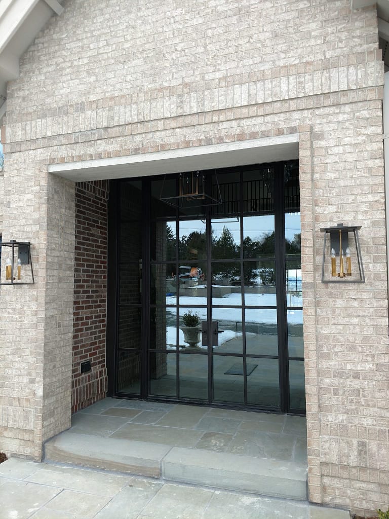 A double swing steel entryway door with side windows by Brombal